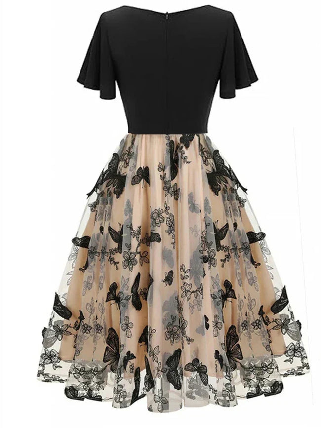 Stijlvolle midikleed van mesh met borduursel en volantmouwen – Maila